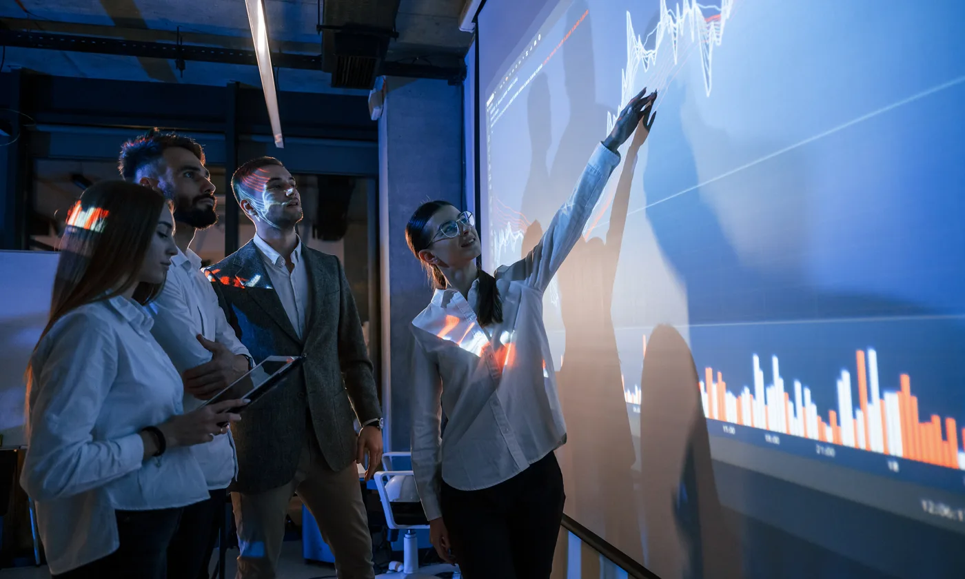 Business team reviewing data together on a presentation screen